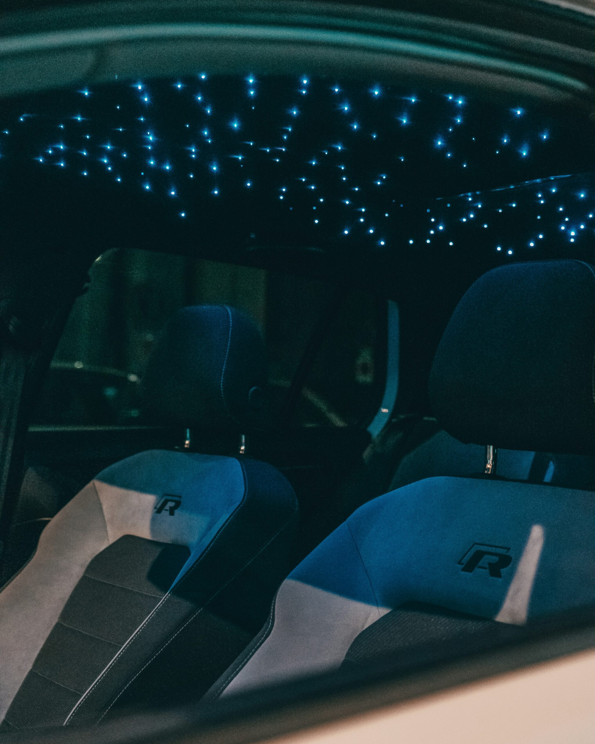 Custom starlight headliner glowing inside a vehicle cabin