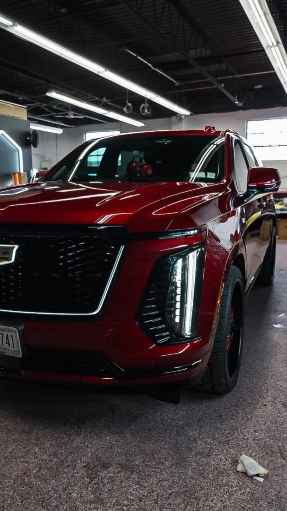 Red Cadillac Escalade with a polished exterior finish